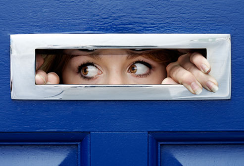 getty_rm_photo_of_woman_looking_out_of_mail_slot.jpg